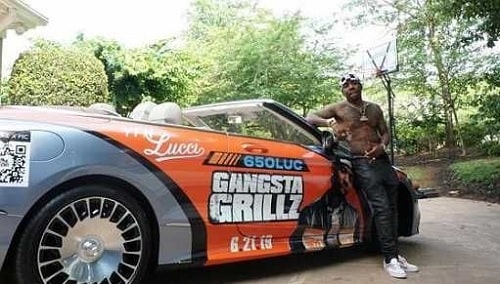 A picture of YFN Lucci showing off his $350K worth Mercedes-Maybach 650 Coupe.